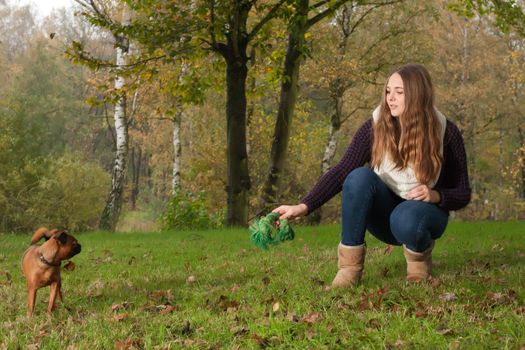 Young teenage girl is having a nice time in the cold november