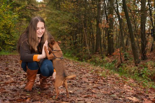 Young teenage girl is having a nice time in the cold november