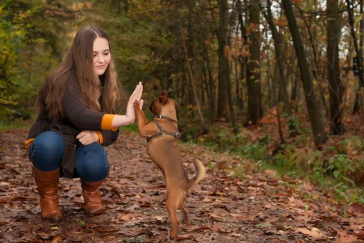 Young teenage girl is having a nice time in the cold november