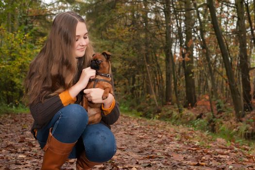 Young teenage girl is having a nice time in the cold november