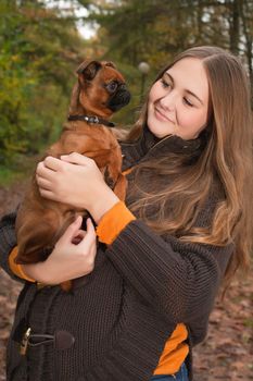 Young teenage girl is having a nice time in the cold november