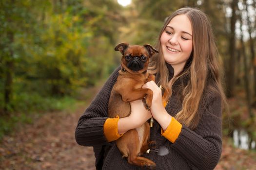 Young teenage girl is having a nice time in the cold november