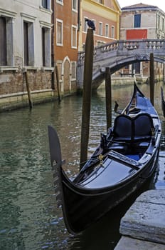 Gondola in a canal of Venice, Italy.