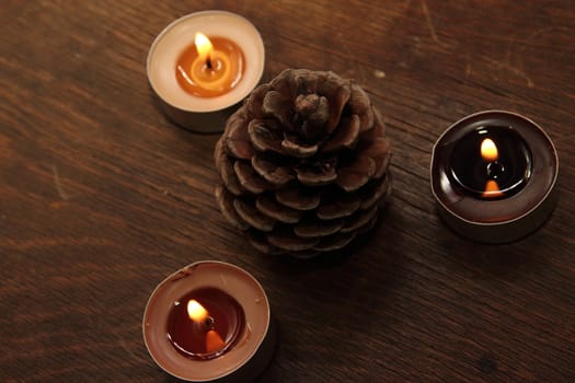 Three candles and bumb in brown tones. Cinnamon and apple