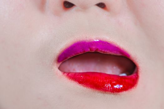 Close up of woman lips with makeup looking disgusted