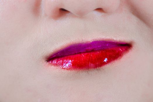 Closeup of woman's lips with makeup with a weird smirk