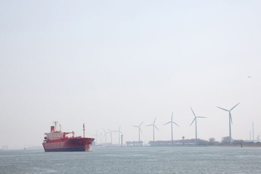 windmills and oil tanker in Nieuwe Waterweg near port of Rotterdam in The Netherlands