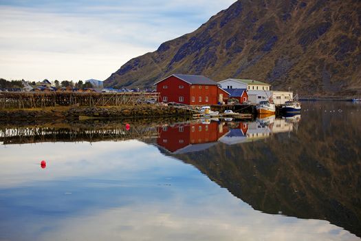 Norwegian rorbu reflecting in quiet water