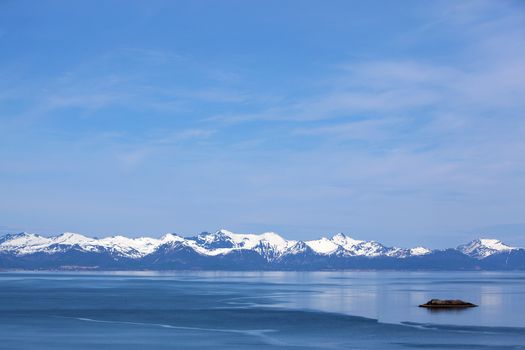 Snowcapped mountains and blue water, Norwegian fjord