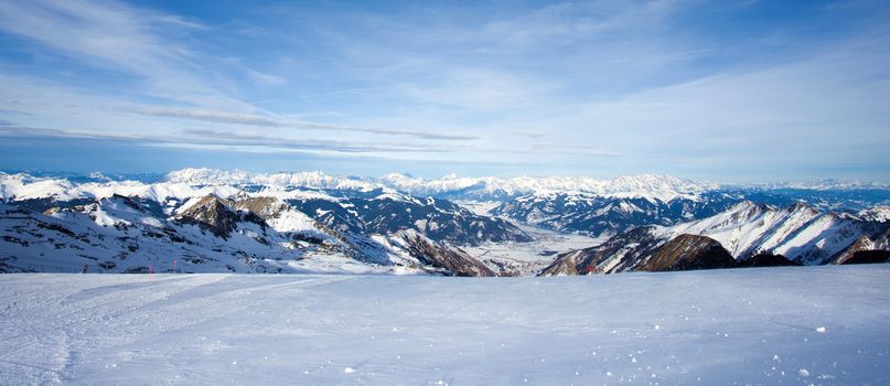 Winter with ski slopes of kaprun resort next to kitzsteinhorn peak in austrian alps