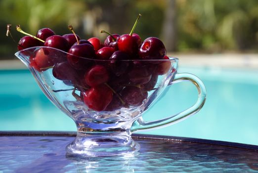 Cherry on the table by the swimming pool