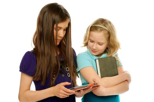 One Girl Uses Tablet PC and Another Girl Keeps Book and Looks with Interest at Device