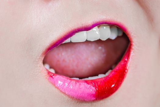 Closeup of woman's lips with makeup yelling out loud