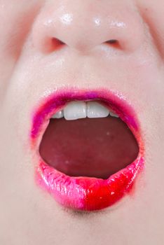 Woman lips with lipsticks smeared on skin