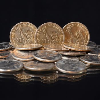 U.S. dollar coins on a black table