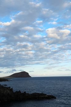 Some Colored Clouds over the Ocean on a Blue Sky