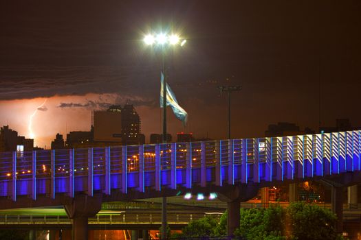 night view of buenos aires in the rain,	
lightning and the Argentine flag