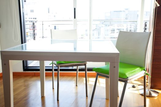 table and chairs in front of windows in the room