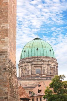 Dome of St Elisabeth church or Elisabethkirche in Nuremberg old town, Nürnberg, Franconia, Bavaria, Germany. Medieval White Tower or Weisser Turm is in the foreground.