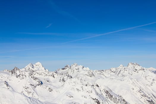 High mountains under blue sky beautiful winter panorama