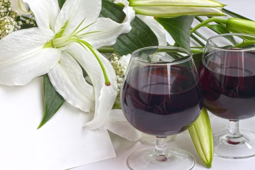 Wine and flowers on white background