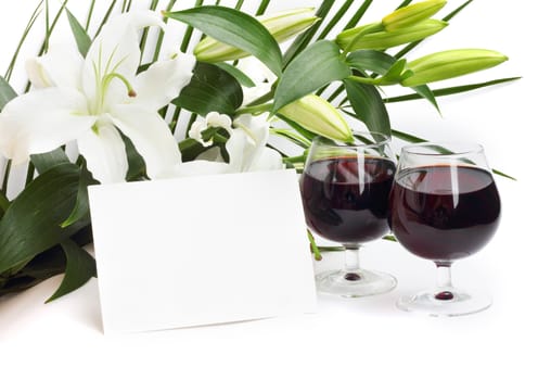 Wine and flowers on white background