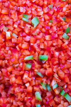 Red and some green belll peppers cleaned and washed as cooking Ingredient in the restaurant, background