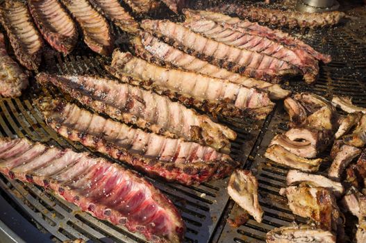 A massive amount of pork ribs on a charcoal grill