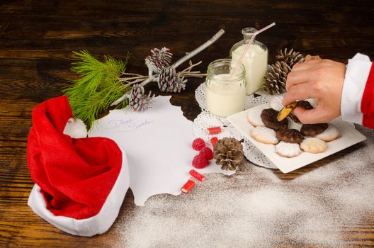 Santas hand taking treats  prepared for him