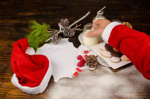 Santas hand taking treats  prepared for him