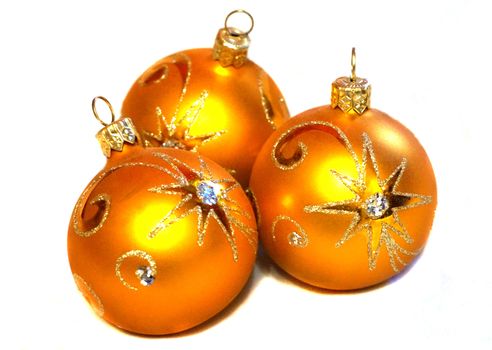 Three orange Christmas balls with golden pattern