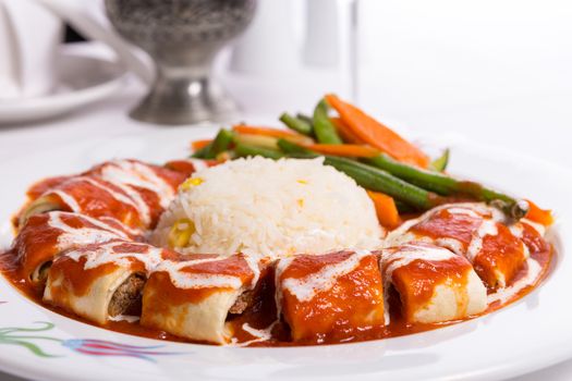 Turkish Beyti Kebap garnished with vegetables