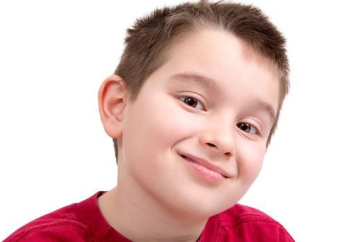 Young boy looking at you appreciatively with a nice smile, isolated on white
