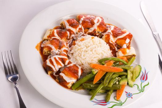 Turkish Beyti Kebap garnished with vegetables