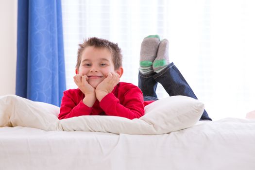 Eight years old kid cheerfully enjoying the morning with Chrismast colors red shirt and green socks