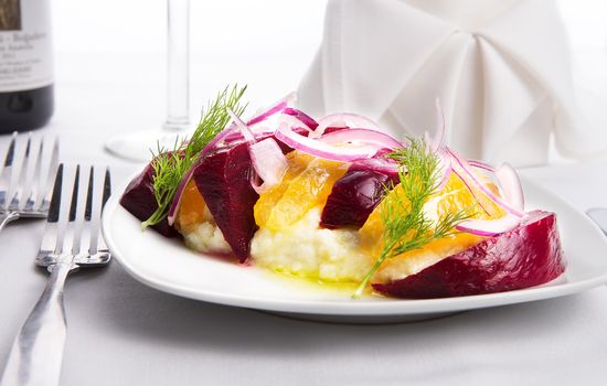 Strained yogurt labneh citrus salad with pickled beets and peeled oranges garnished with onions and dill served with oil