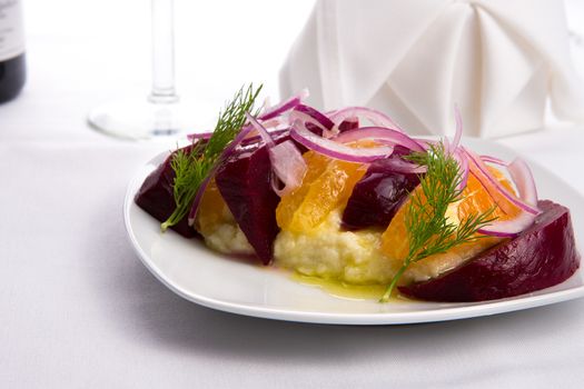 Strained yogurt labneh citrus salad with pickled beets and peeled oranges garnished with onions and dill served with oil