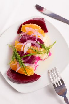 Strained yogurt labneh citrus salad with pickled beets and peeled oranges garnished with onions and dill served with oil