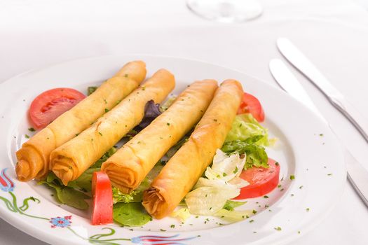Turkish style cheese stuffed filo dough rolls served along on lettuce leaves along with tomatoes