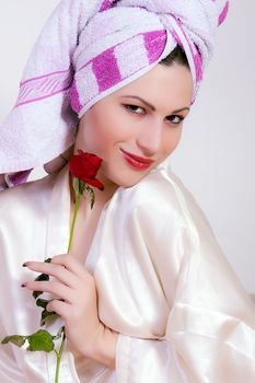 portrait of beautiful young smiling woman with a flower