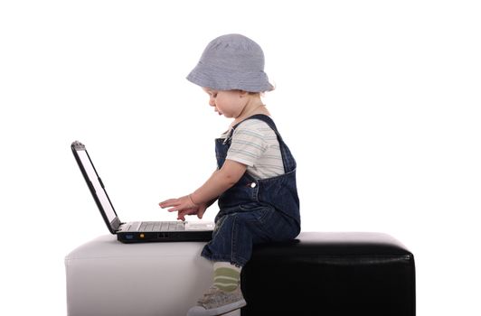 Little boy sitting with a laptop isolated on the white