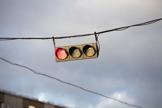 Traffic light on the background of the storm sky