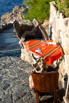 Original handmade wooden table and two chairs outdoor
