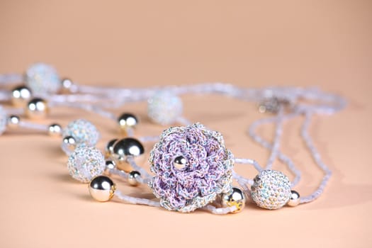 Silver and violet beads at pink background
