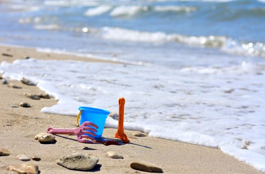 Plastic bucket on the beach near the sea