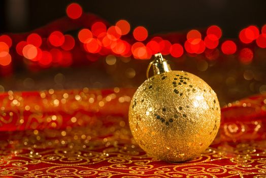 Golden Christmas ornament with red blur lights