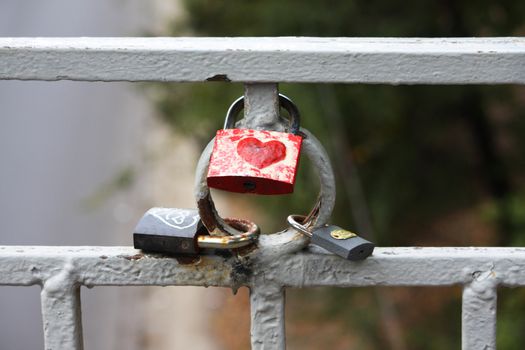 Some locks with heart on a fence