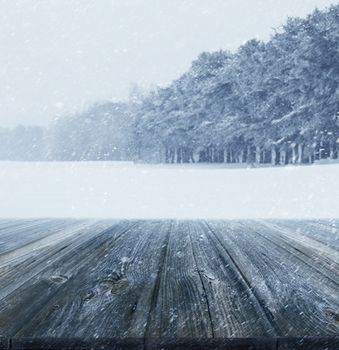 Winter background with wood planks in forefront