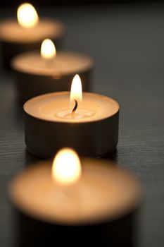 several tealights with wooden background