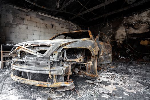 Close up photo of a burned out car in garage after fire for grunge use